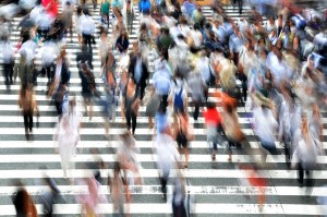 Muitas pessoas desconhecidas atravessando a rua